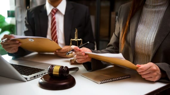 business-lawyers-discussing-contract-papers-with-brass-scale-desk-office-law-legal-services-advice-justice-law-concept_533878-38